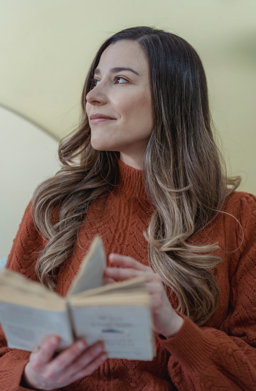 dreamy woman flipping page of book